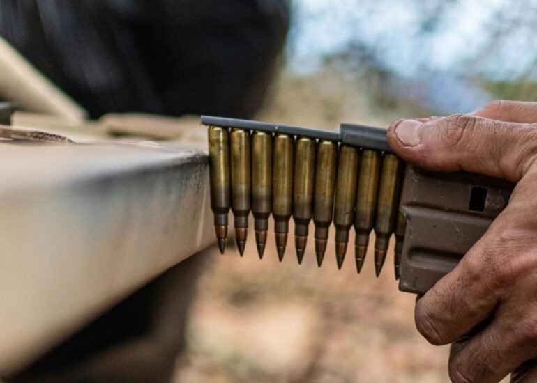 a man is holding a rifle and aiming it at something