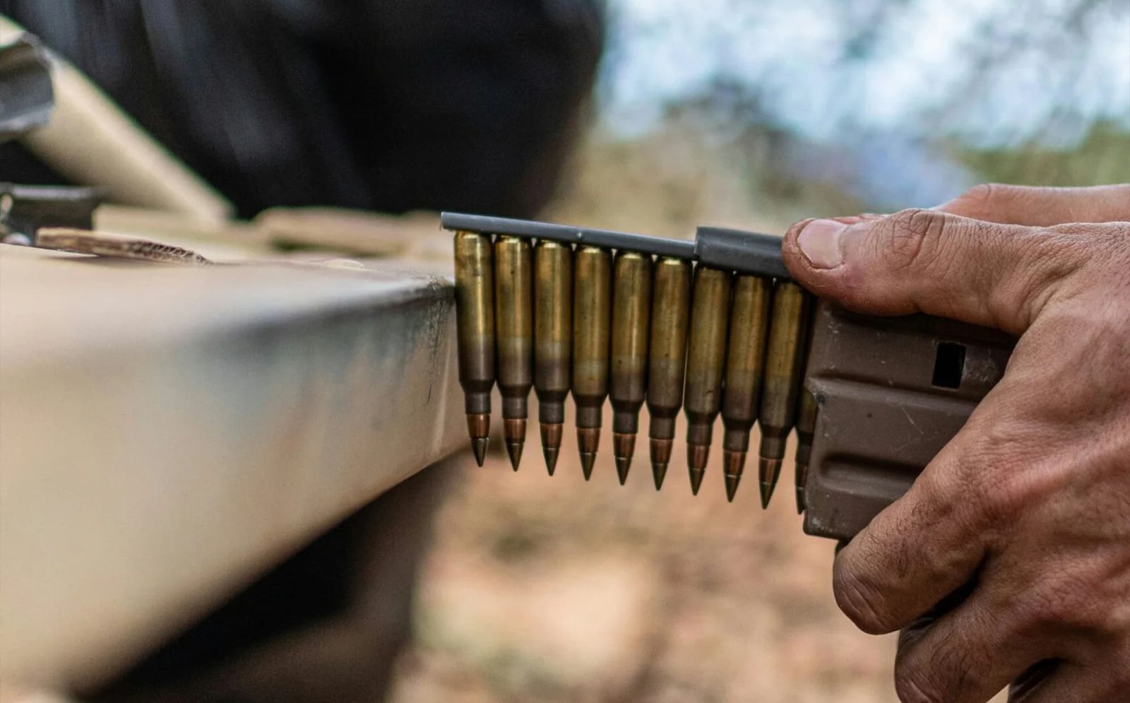 a man is holding a rifle and aiming it at something